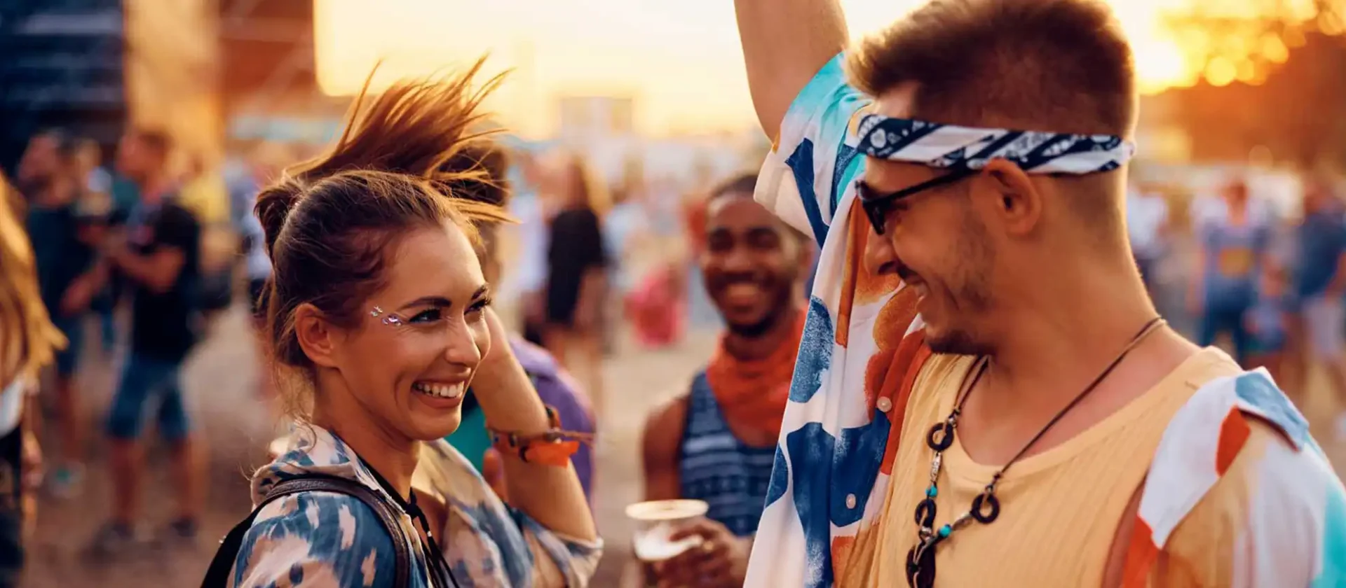 Friends enjoying a lively outdoor festival at sunset at Wvec West Valley Events Complex in Phoenix, Arizona.