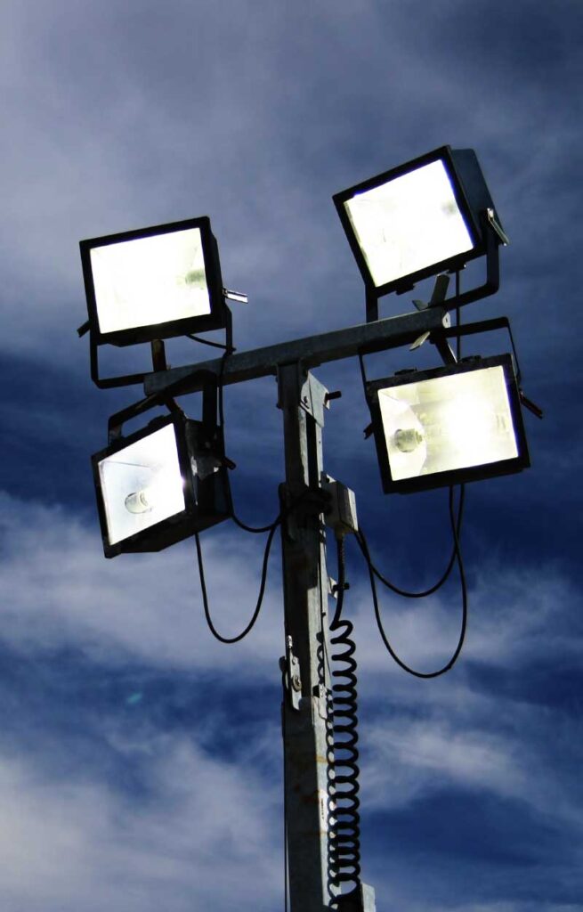 Bright stadium lights illuminating outdoor sports and events at Wvec West Valley Events Complex, Phoenix, Arizona.